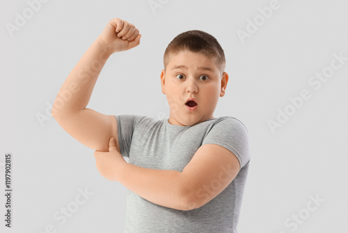 Shocked overweight boy with...