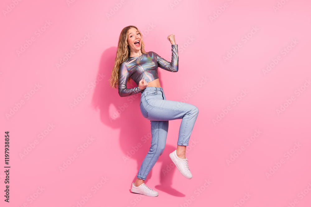 Fototapeta premium Happy young woman in stylish shiny top enjoying the moment
