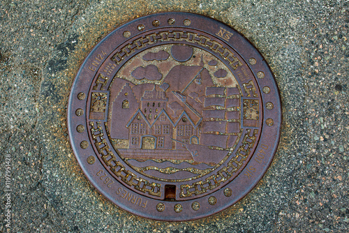 Bergen manhole cover depicting sailing ships and trading houses