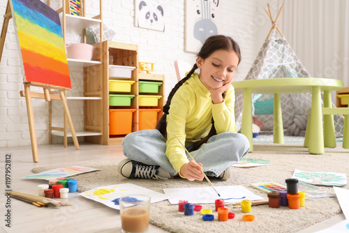 Happy young girl painting o...