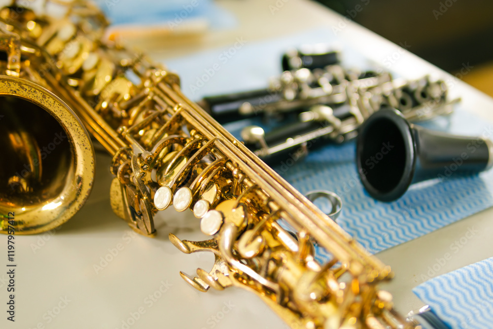 Fototapeta premium Golden saxophone and clarinet resting on table after cleaning