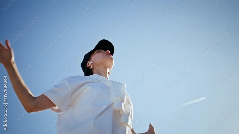 Meditative woman exercising nature stretching arms wearing cap closeup. Meditative woman exercising nature stretching arms wearing cap closeup.