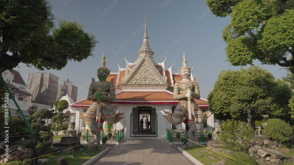 Two giant Yaksha statues at Wat Arun. Wat Arun, also known as the Temple of Dawn, is a famous Buddhist temple located on the banks of the Chao Phraya River Bangkok, Thailand