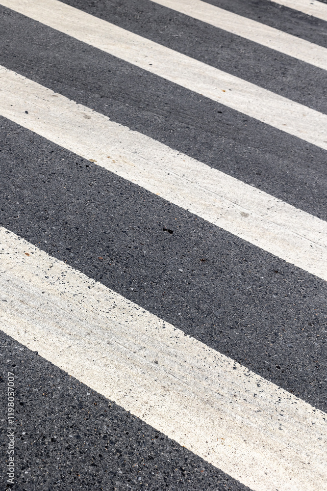 Close-up of a urban pedestrian crosswalk with textured asphalt patterns Close-up of a urban pedestrian crosswalk with textured asphalt patterns