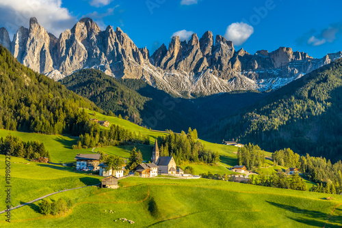 Panorama of Santa Maddalena village and church in the Dolomites, Puez Odle national park in Italy. Italian Dolomiti Alps scenic landscape in summer with beautiful sunlight at sunset