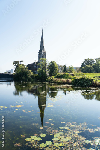 Green park and Kastellet water moat near Saint Alban's Church - traditional English Anglican church. Copenhagen, Denmark. photo