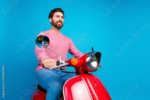Confident man in casual attire riding a vintage red scooter against a vibrant blue background
