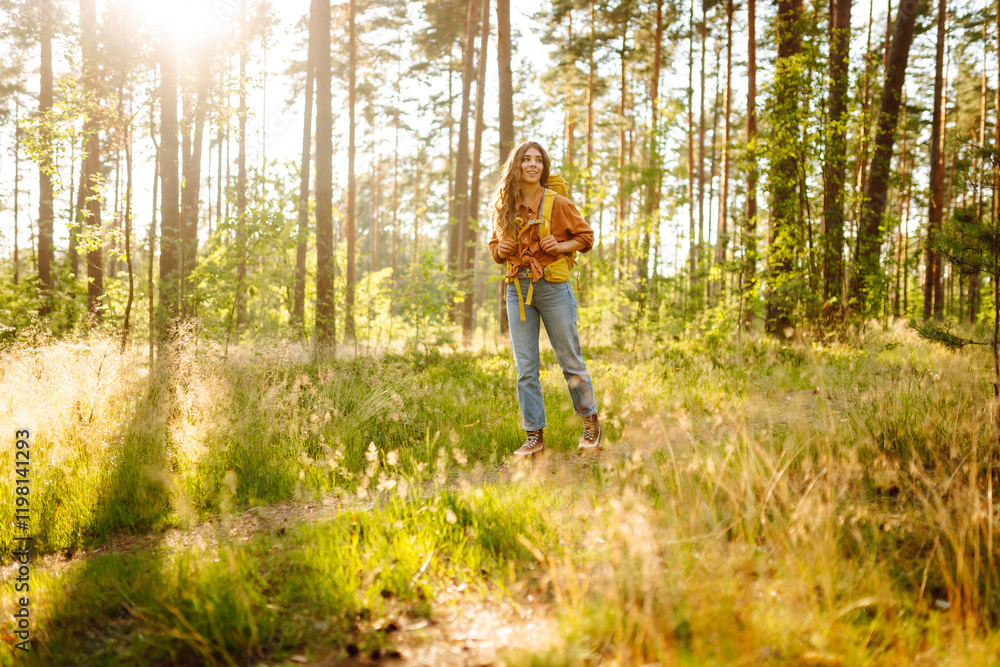 Woman tourist with backpack is relaxing in the fresh air in the forest, feeling happiness and connection with nature. Woman tourist with backpack is relaxing in the fresh air in the forest, feeling happiness and connection with nature.