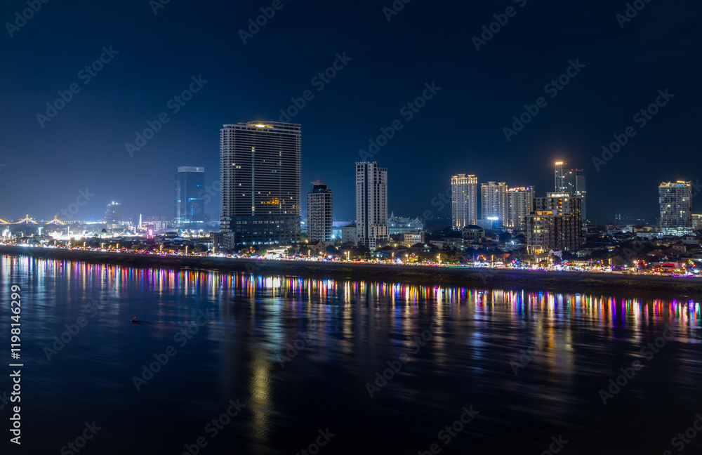 Obraz premium Tonle Sap river bank with modern buildings and residential areas district night panorama, Phnom Penh city panorama, Cambodia