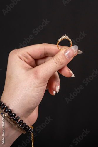 Gros plan d'une bague dans une mains entre deux doigts photo