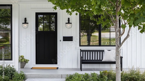 Charming modern farmhouse front porch featuring a sleek black door.