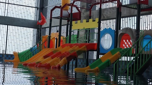 Children's Playground with Yellow and Blue Plastic Sliders at the Aquapark Swimming Pool photo