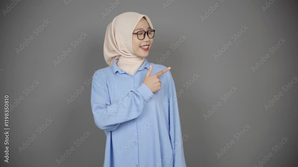 Woman hijab pointing to the side Woman hijab pointing to the side