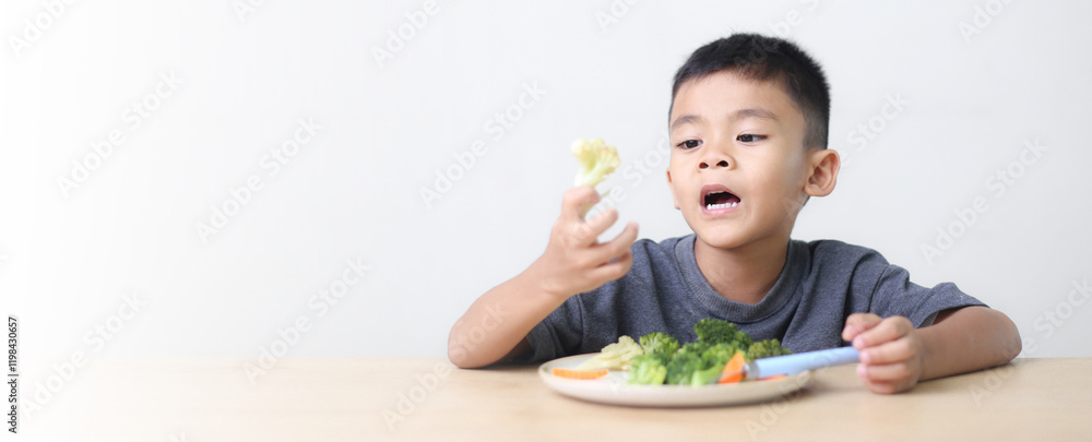 Nutrition healthy eating habits for kids concept. Children do not like to eat vegetables. Little cute boy refuses to eat healthy vegetables.