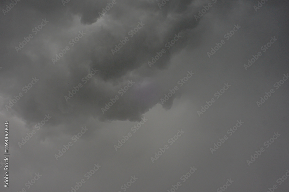 The dark sky with heavy clouds converging and a violent storm before the rain.Bad or moody weather sky and environment. carbon dioxide emissions, greenhouse effect, global warming, climate change. The dark sky with heavy clouds converging and a violent storm before the rain.Bad or moody weather sky and environment. carbon dioxide emissions, greenhouse effect, global warming, climate change.