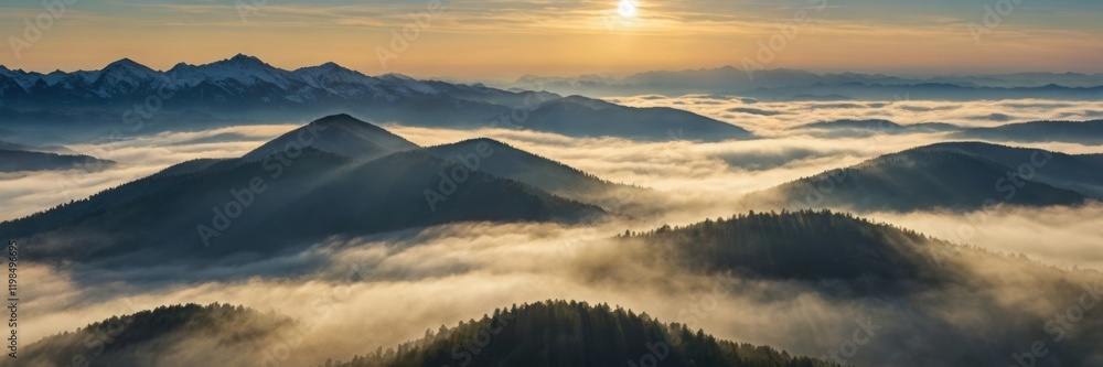 Foggy morning over a towering mountain range, the sun just peeking through Foggy morning over a towering mountain range, the sun just peeking through