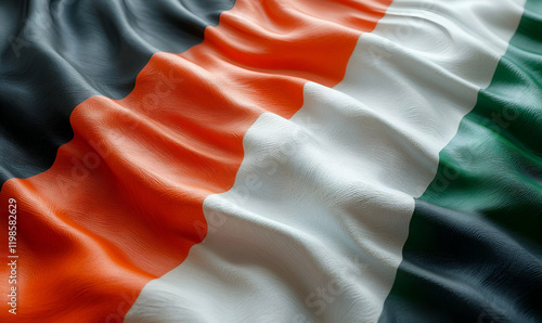 Waving Ivorian flag, close-up, dark background, patriotic photo