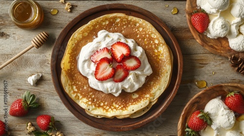 Wallpaper Mural 62.A top-down view of golden-brown crepes folded neatly on a rustic wooden plate, topped with dollops of fresh whipped cream, sliced strawberries, and a drizzle of honey. Torontodigital.ca