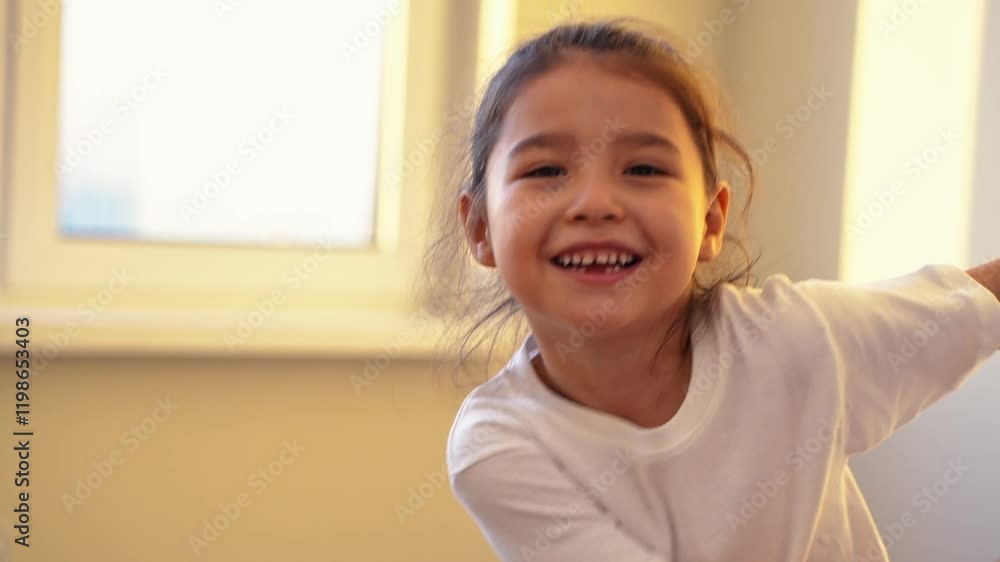 view of active awake little girl 5 years old having fun singing favorite song enjoying hobby in morning spending leisure time jumping in room. High quality 4k footage view of active awake little girl 5 years old having fun singing favorite song enjoying hobby in morning spending leisure time jumping in room. High quality 4k footage