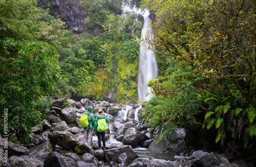 Obraz na płótnie Couple enjoying the view of Dawson Falls in the rain. Egmont National Park. Taranaki. w salonie