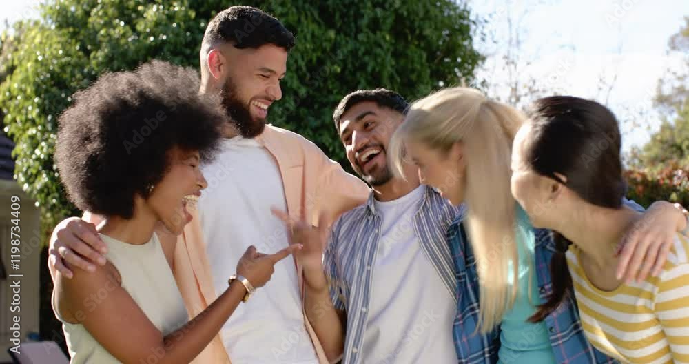 Group of young friends laughing and hugging outdoors, enjoying time together Group of young friends laughing and hugging outdoors, enjoying time together