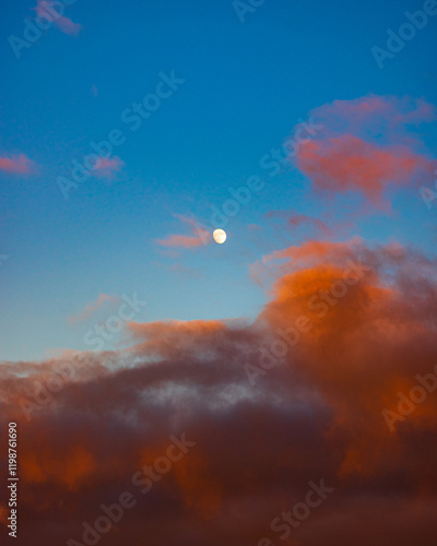 Waxing Moon over Sunset drenched Clouds photo