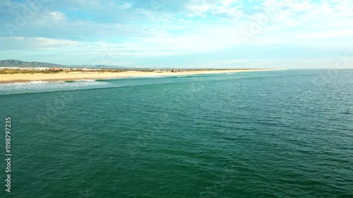 Drone flying low over Atlantic Ocean towards to Culatra island Beach, Algarve Coastline photo