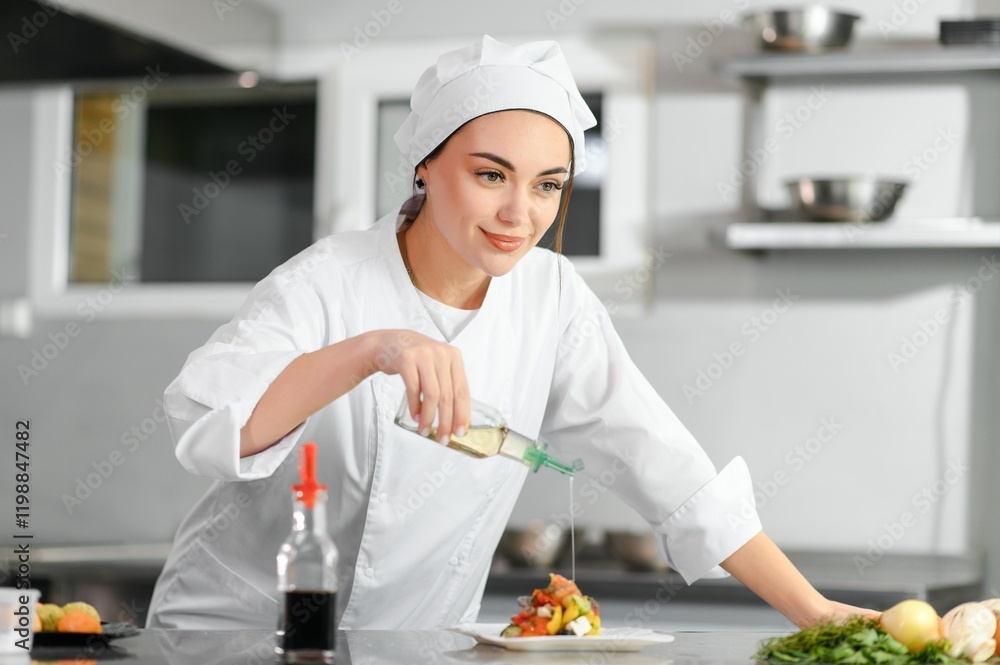 young beautiful smiling woman chef wearing in white suit at kitchen. Blurred background