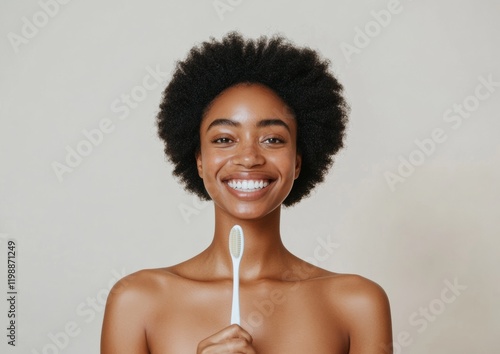 Minimalist Glow A Radiant Black Woman, 30, with Perfect White Teeth Holding a Toothbrush in a Modern Bathroom - Elevating Oral Care Branding and Wellness Lifestyle Imagery photo