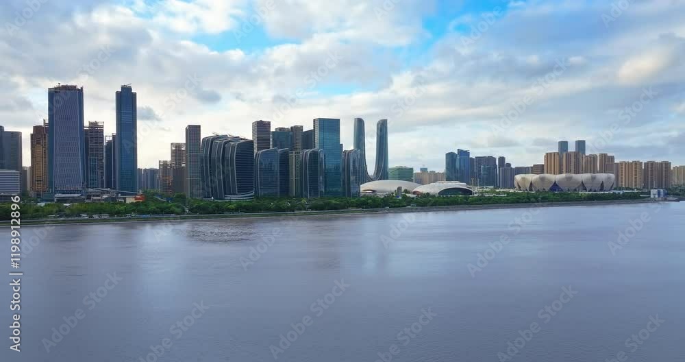 Aerial shot of modern city skyline at waterfront with river and cloudy sky background in Hangzhou Aerial shot of modern city skyline at waterfront with river and cloudy sky background in Hangzhou