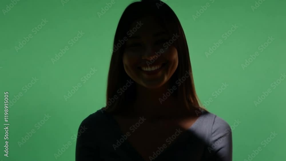 Silhouette of Smiling Woman: A mysterious and alluring silhouette of a woman with a radiant smile, set against a vibrant green backdrop. Silhouette of Smiling Woman: A mysterious and alluring silhouette of a woman with a radiant smile, set against a vibrant green backdrop.