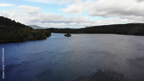 Aerial staionary shot of Loch Eilein in the Scottish Highlands with the wind blowing over the Loch photo