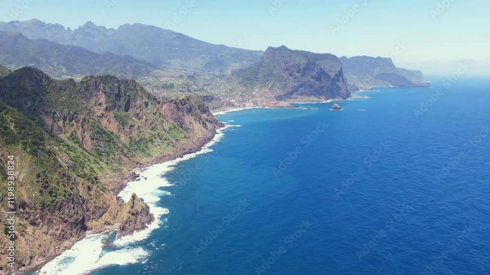 Time lapse of Blue ocean waters crashing against the scenic coastline revealing the rugged cliffs at Verada do Larano near Boca do Risco in Madeira, Portugal Aerial drone 4k view Time lapse of Blue ocean waters crashing against the scenic coastline revealing the rugged cliffs at Verada do Larano near Boca do Risco in Madeira, Portugal Aerial drone 4k view