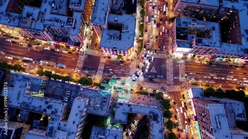 Busy urban intersection at night showcasing vibrant city life and traffic patterns photo