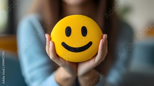 Woman holding smiley face cushion, indoors, blurred background, positive feedback concept