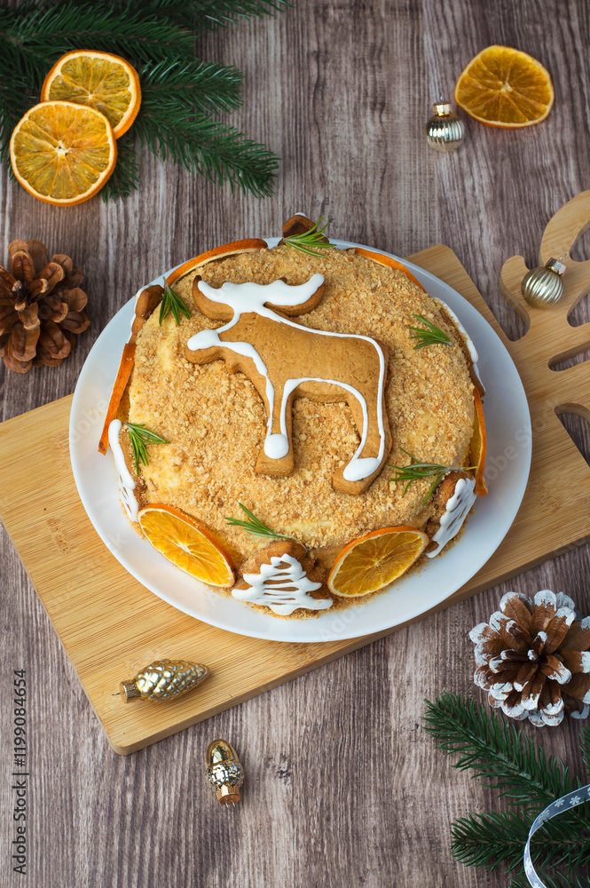 Fototapeta premium New Year's cake, Christmas decorated with gingerbread and oranges on a wooden background. Homemade honey cake.