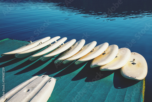 Obraz na płótnie A row of Paddle Boards on the beach w salonie