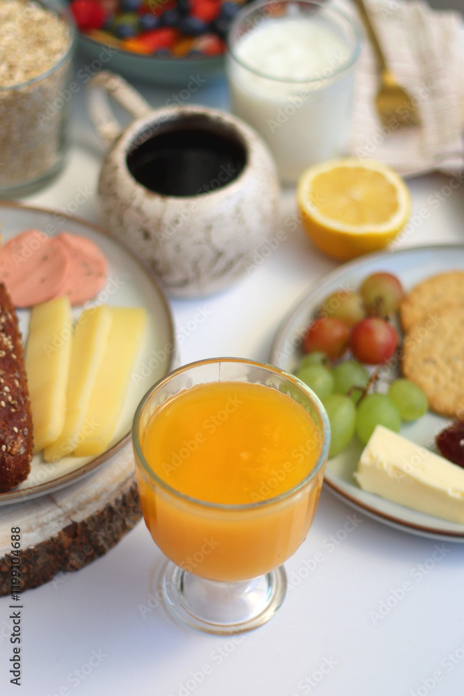 Assortment of various breakfast foods and drinks on the white table. Selective focus. Assortment of various breakfast foods and drinks on the white table. Selective focus.