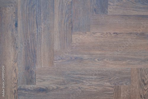 A wooden floor with a checkered pattern. The floor is made of wood and has a brown color photo