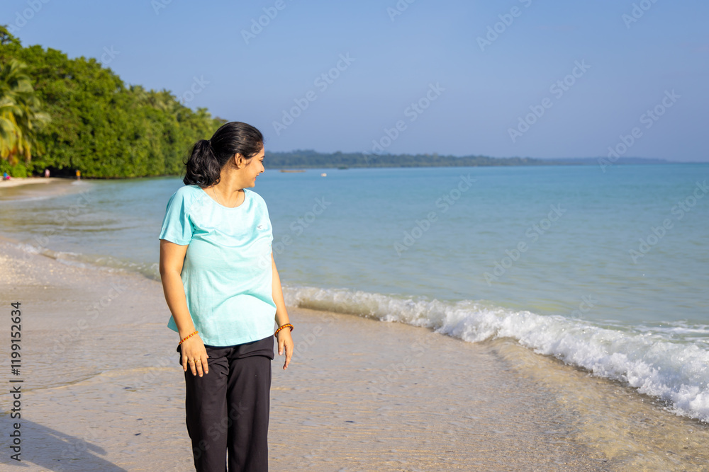 Isolated Girl looking at sea horizon from Sandy Beach Shore with rolling waves in Morning Isolated Girl looking at sea horizon from Sandy Beach Shore with rolling waves in Morning