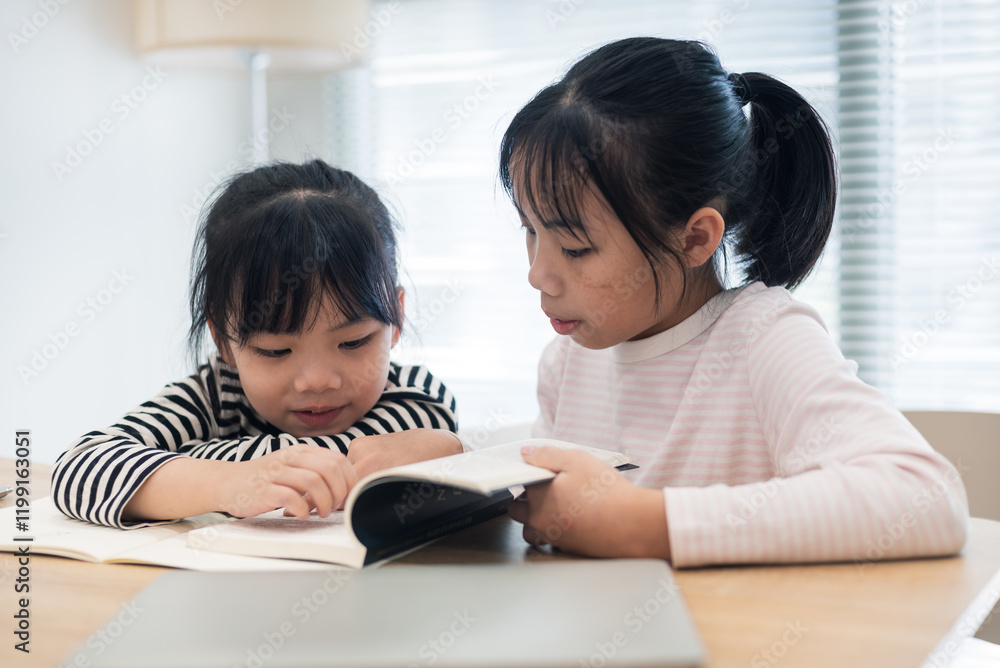 Asian two little girl studying together at home Asian two little girl studying together at home
