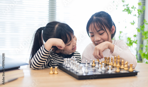 Asian little girl playing chess together