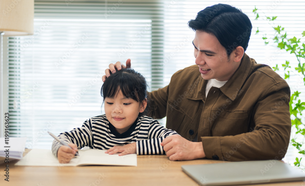 Young Asian father and daughter studying together Young Asian father and daughter studying together