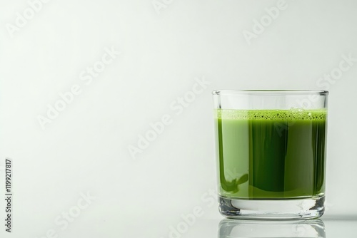 Fresh green juice in clear glass, showcasing vibrant color and s
