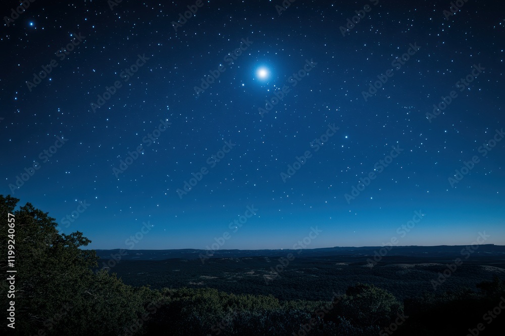 Naklejka premium Starry night sky with a bright glowing moon above a forested landscape