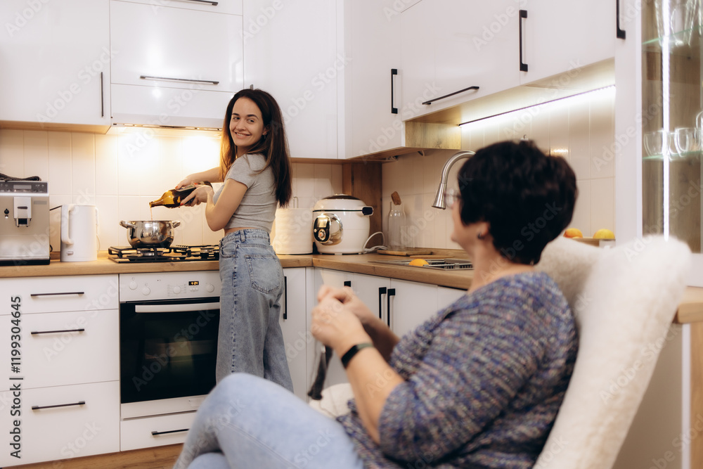 A woman makes mulled wine at home in the kitchen. A smiling woman A woman makes mulled wine at home in the kitchen. A smiling woman