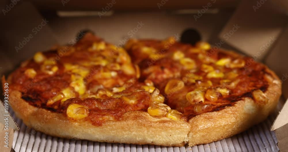 Delicious corn pizza in an open cardboard box with focus shift, Food concept Delicious corn pizza in an open cardboard box with focus shift, Food concept