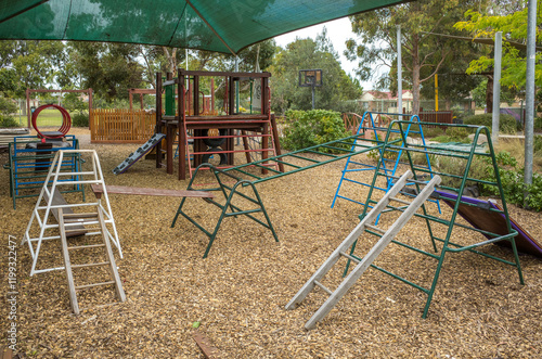 Children's climbing frames and some play equipment at the outdoor playground of a kindergarten or childcare center in Australia photo