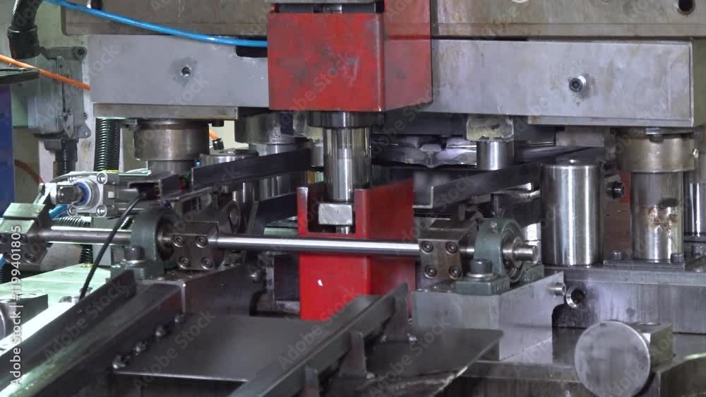 Close up view of a large hydraulic transfer press line shaping metal parts in a factory. Close up view of a large hydraulic transfer press line shaping metal parts in a factory.
