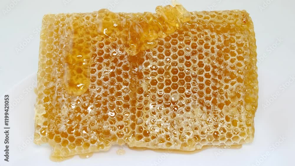 honey flowing over natural honeycomb